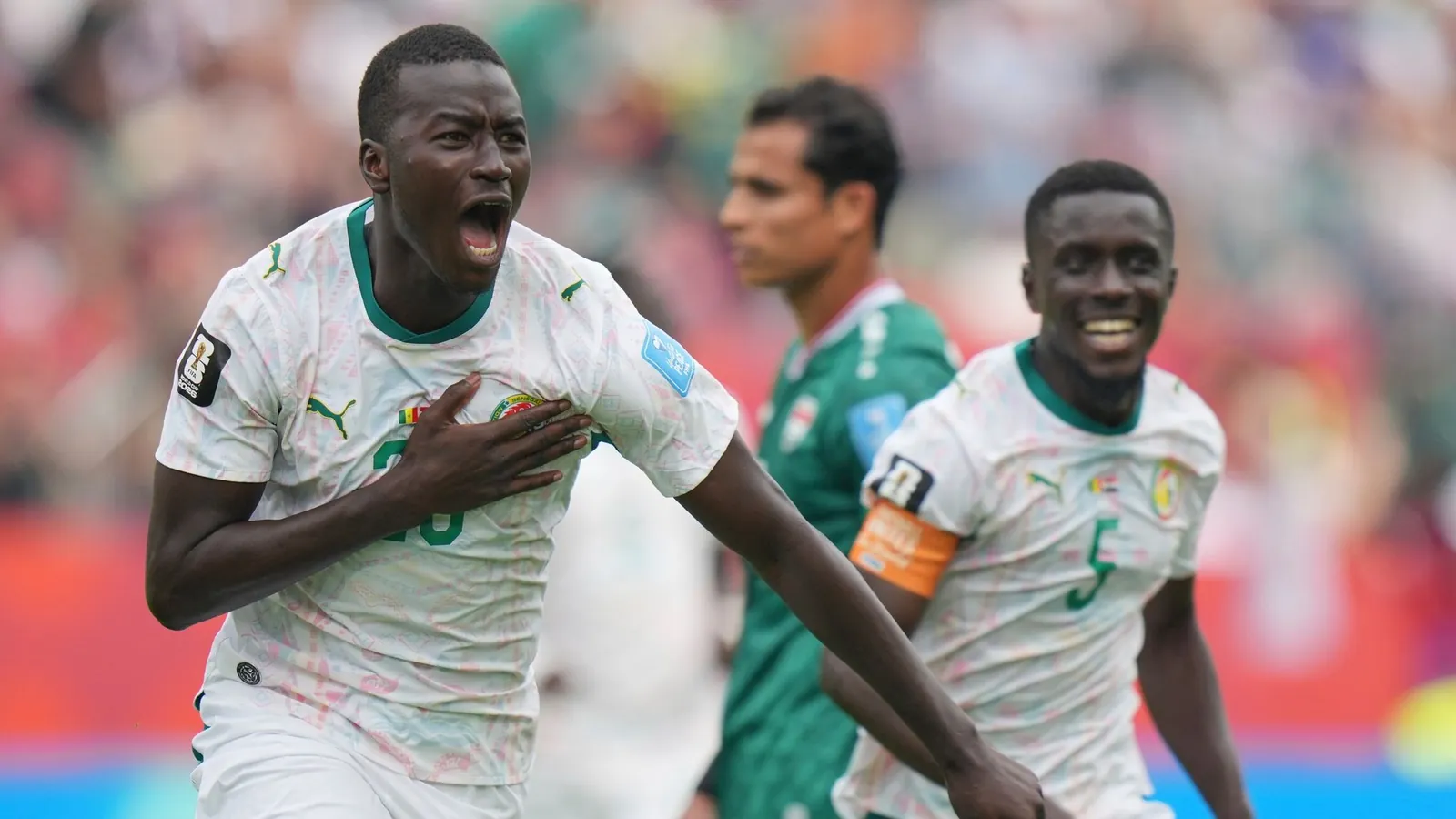Senegal's Pape Gueye (26) celebrates their third goal during the World Cup Group I soccer match between Senegal and Iraq in Toronto, Friday, June 26, 2026. (AP Photo/Stephanie Scarbrough)