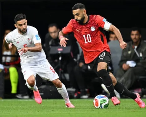 Milad Mohammadi chases down Mo Salah as the second half between Egypt and Iran gets under way in Seattle.