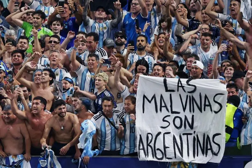 Argentina fans display a banner with a message referencing the Falkland Islands as they celebrate after the match